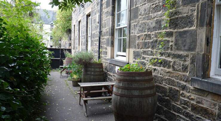 green garden bench table castle rock hostel