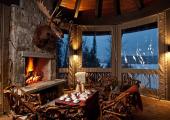 dining beside stone fireplace view ot lake placid