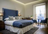 luxury hotel bedroom king size bed blue sheets the reaburn